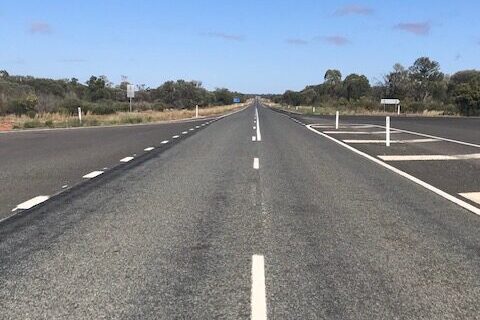 Symmetrical image of road to the horizon symbolizing road trip and exploration travel