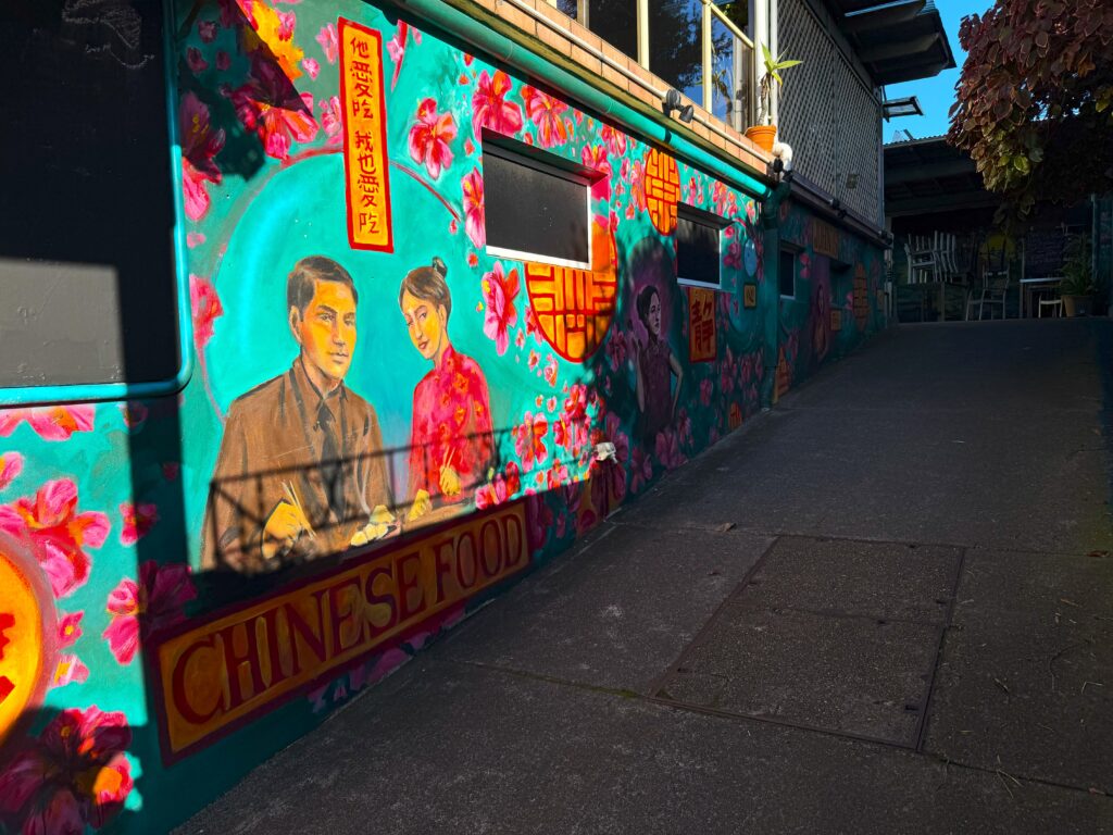 Mural at the entrance to the Hawker Inn on the Nelson Bay Art Walk showing a Chinese couple sitting down for a meal
