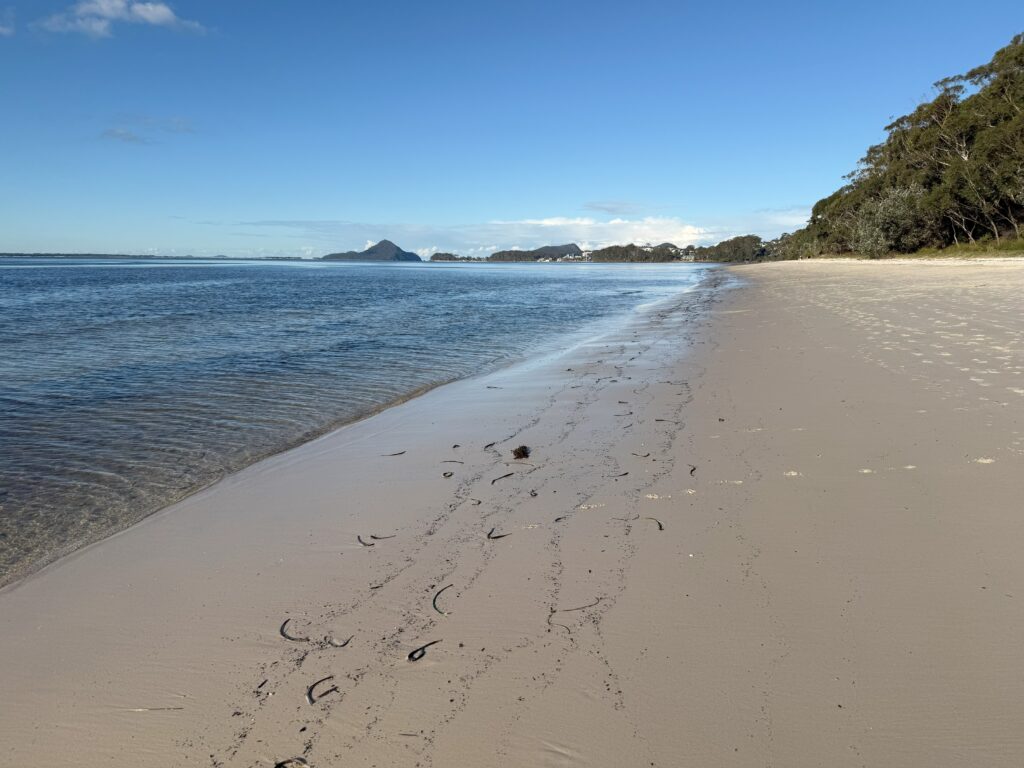 Bagnalls Beach, Port Stephens with sandy beach and clear water to Tomaree Headland in the distance