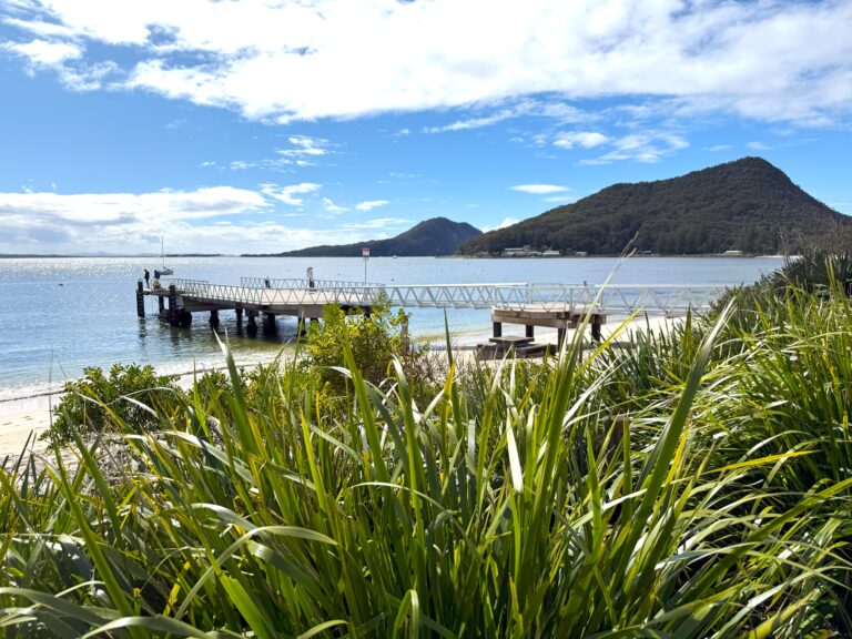 Men fishing off the Shoal Bay jetty looking towards Tomaree headland