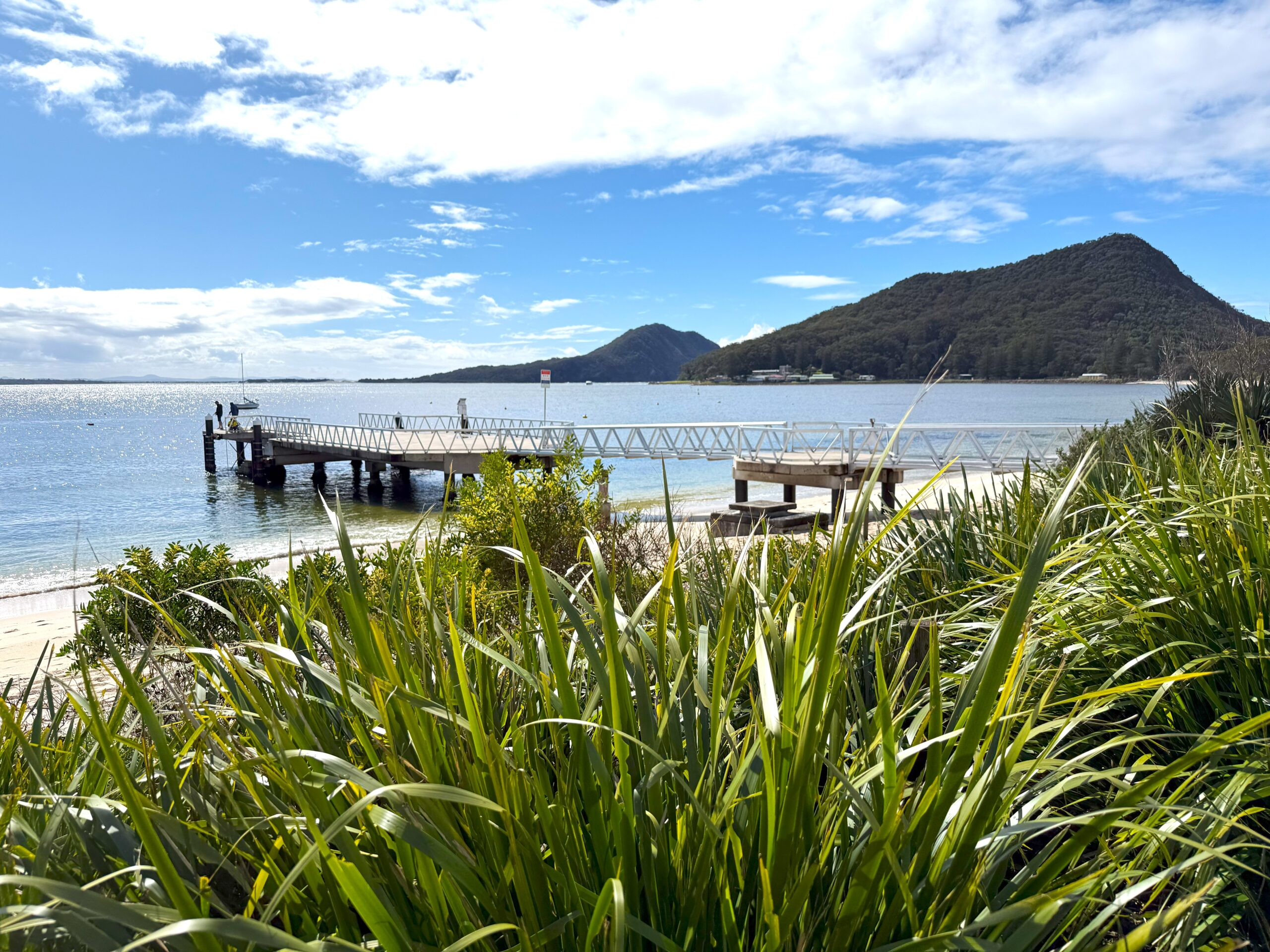 Men fishing off the Shoal Bay jetty looking towards Tomaree headland