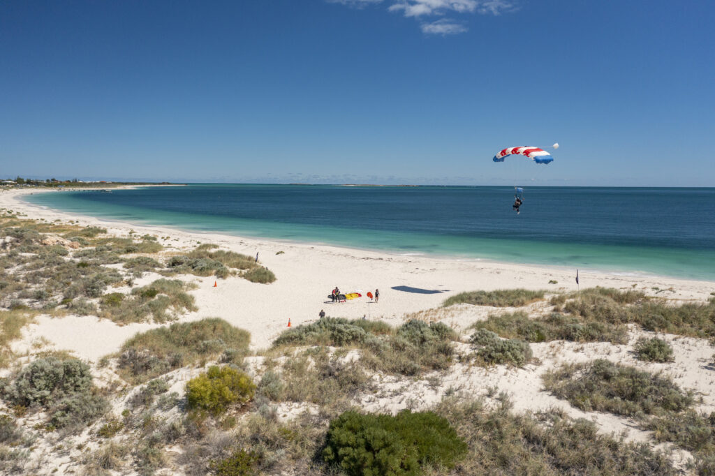 Skydiver coming landing on the powdery white beaches of Jurien Bay, Western Australia