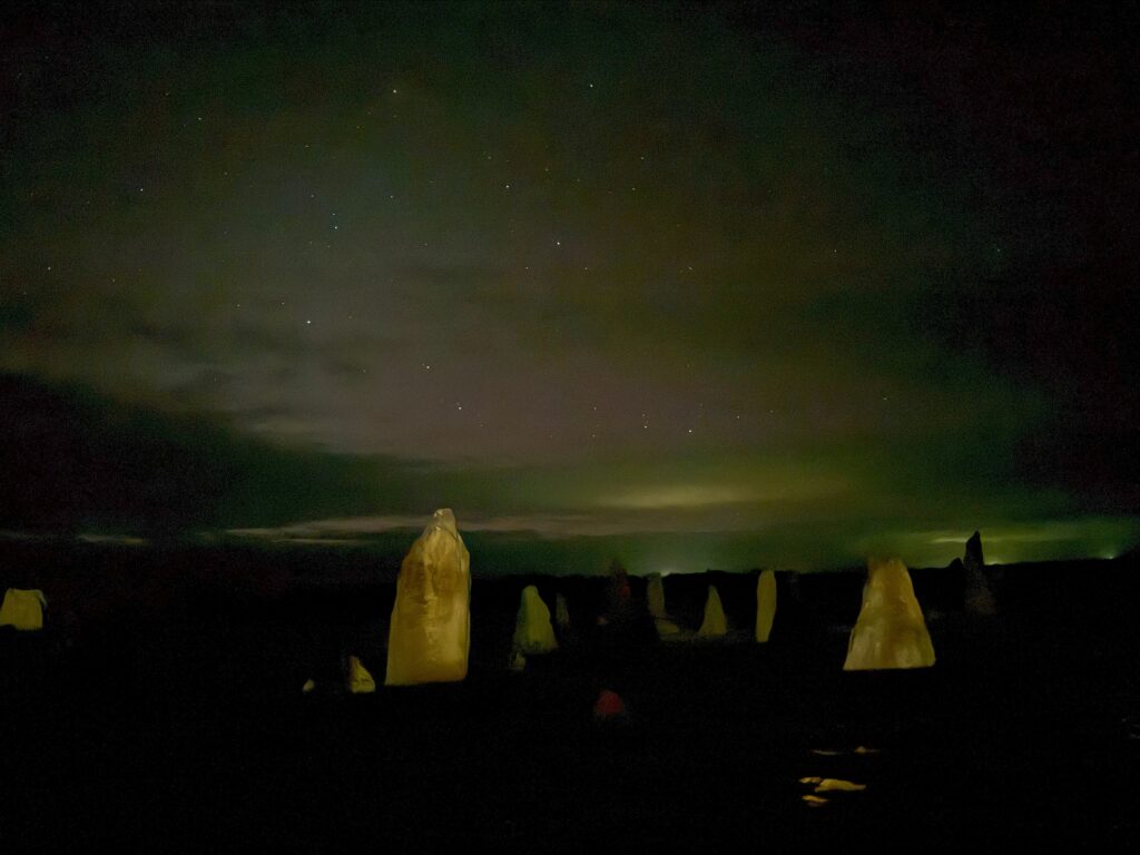 Star gazing at the Pinnacles, the limestone pillars are illuminated beneath the star filled desert sky
