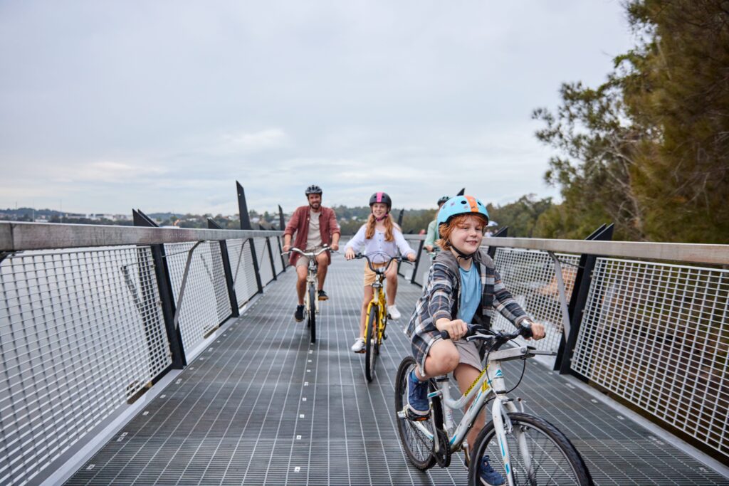 Family cycling around Lake Macquarie on one of the boardwalks
