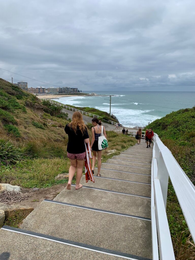Stairs from the King Edward Park Lookout to the Bogey Hole. Newcastle Beach and Newcastle can be seen in the distance
