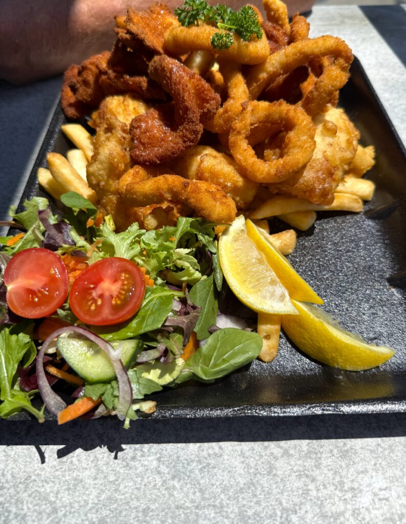 Seafood platter for 2 -crumbed calamari, battered flathead, prawns and scallops served with chips and salad.