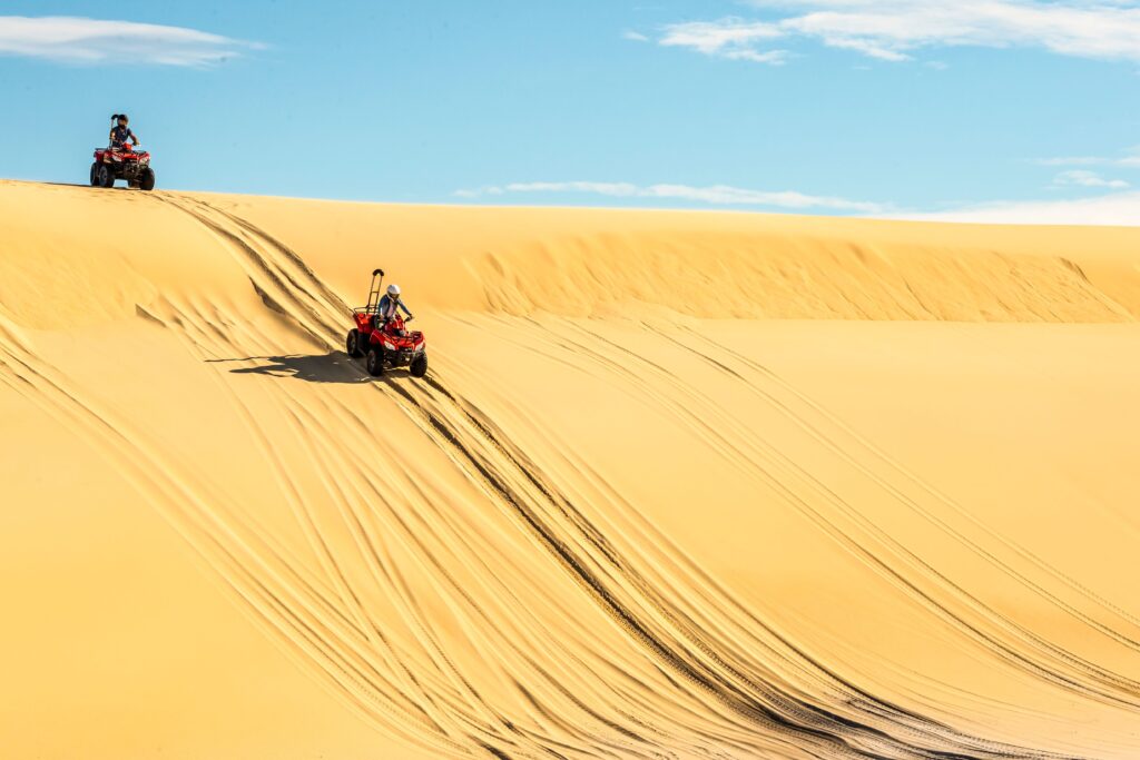 Riding down the Stockton Sand Dunes on a quad bike with Quad Bike King, Port Stephens