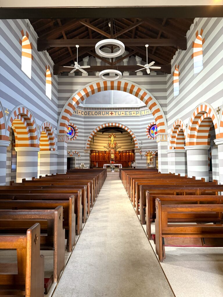 Looking down the aisle with pews either side at St Francois Xaviers Cathedral