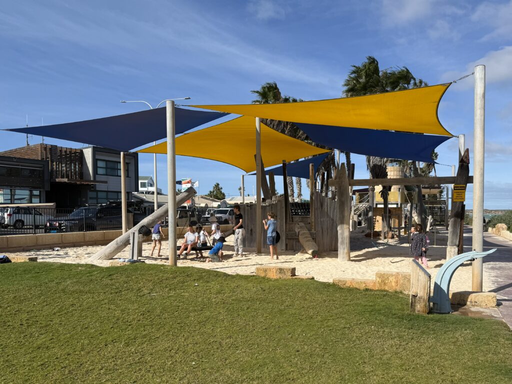 Kids playing on the shipwreck inspired playground on the foreshore at Denham