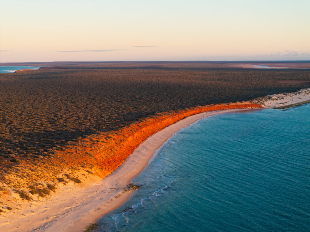 Stunning red cliffs contrasting with white sandy beaches and incredibly blue water at Francois Peron National Park, Shark Bay