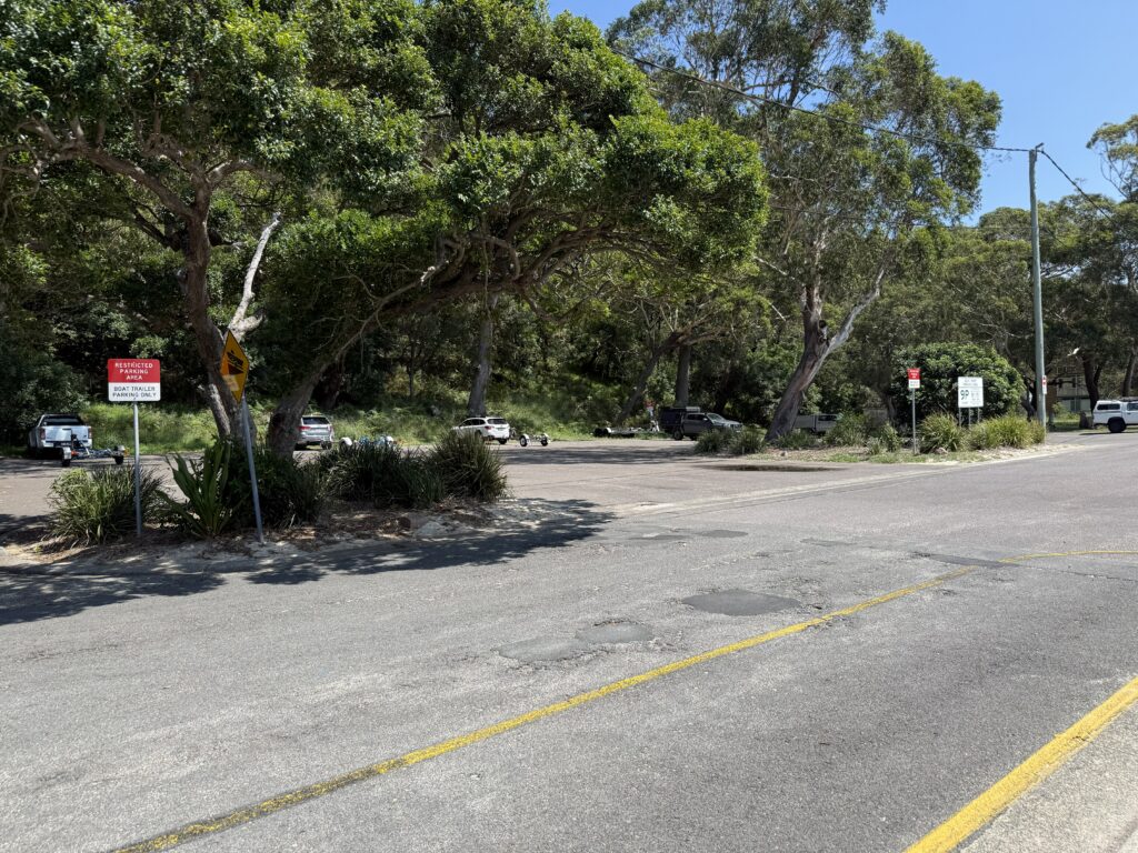 Gravel paid trailer parking area opposite the Shoal Bay Boat Ramp