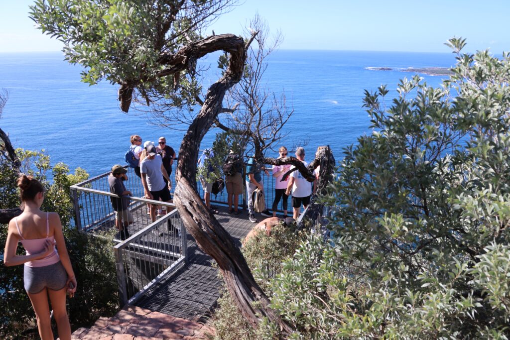 Hikers enjoying a rest and the view of Fingal Spit from Tomaree Head Summit.