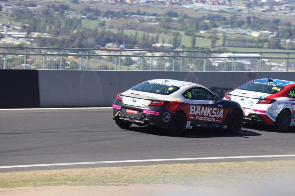 Development series Toyota GAZOO racing car traverses Skyline at the top of Mount Panorama with views of the surrounding farmlands.