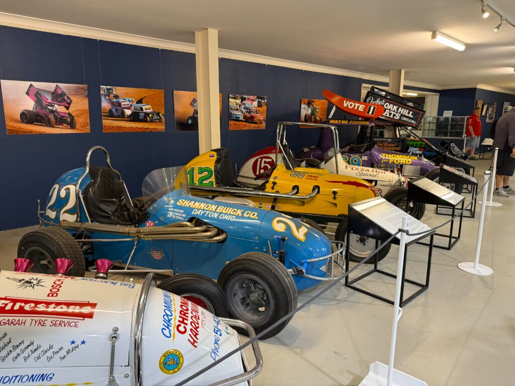 6 Sprint Cars showing their evolution through the decades finishing with huge wings on their roof to create added downforce