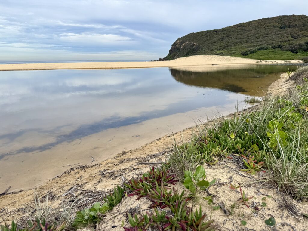 Clouds reflect in the still waters of Glenrock Lagoon