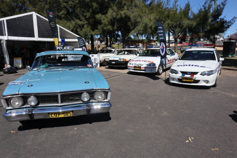 Police car exhibition showcasing 5 different eras of police cars at the National Motor Racing Museum