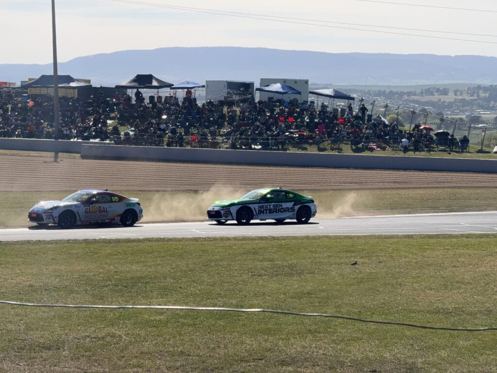 Toyota 86s pushing the brakes at Conrod Straight run a little wide sending up a plume of dust