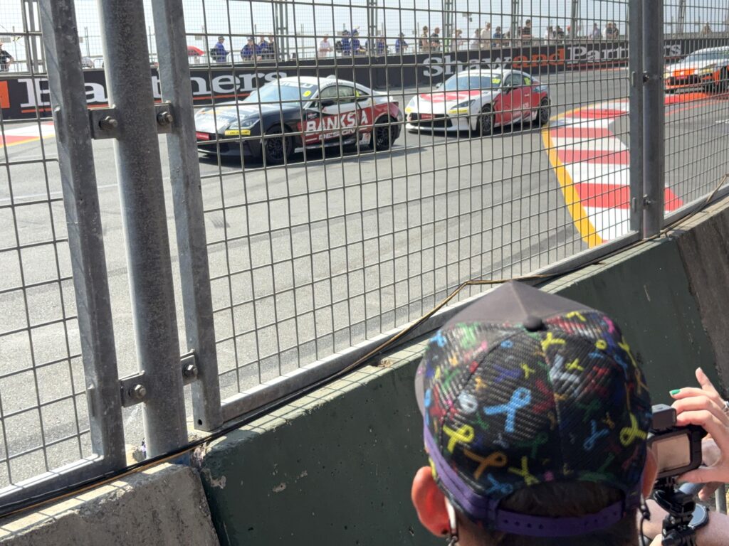 Toyota 86s racing through the Chicane at the Gold Coast 500 in the Toyota Gazoo Racing Cup as seen by spectators behind the concrete walls