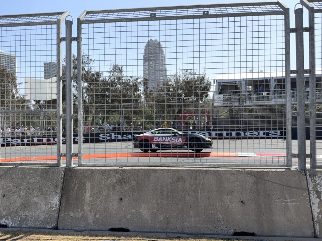 Toyota 86 navigating the Chicane overlooked by fan Grandstand at the Gold Coast 500