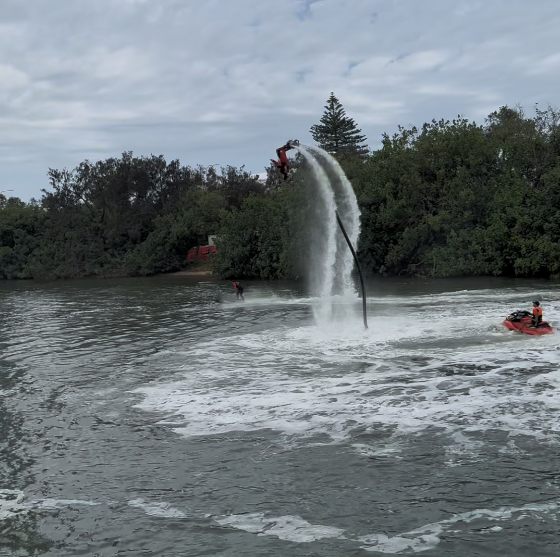 Jet board rider completes a 360 degree roll over powered by water jet during demonstration at the Gold Coast 500
