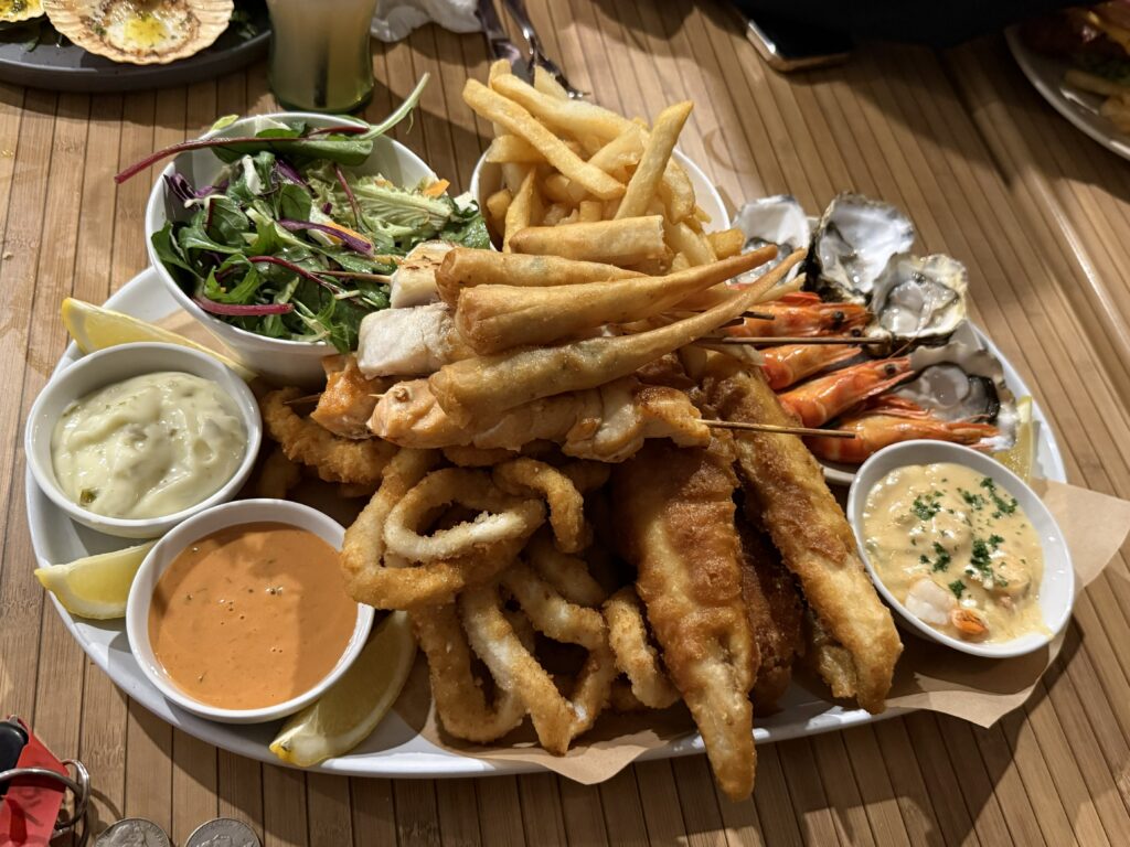 The Club Platter at the Game Fishing Club with oysters, prawn twisters, creamy garlic prawns, fresh prawns, battered flathead, barramundi skewers, red salmon skewers, calmari and chips.