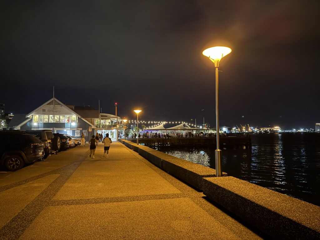 Newcastle Harbour Foreshore Walk at night with popular live music venue at the Queens Wharf Hotel