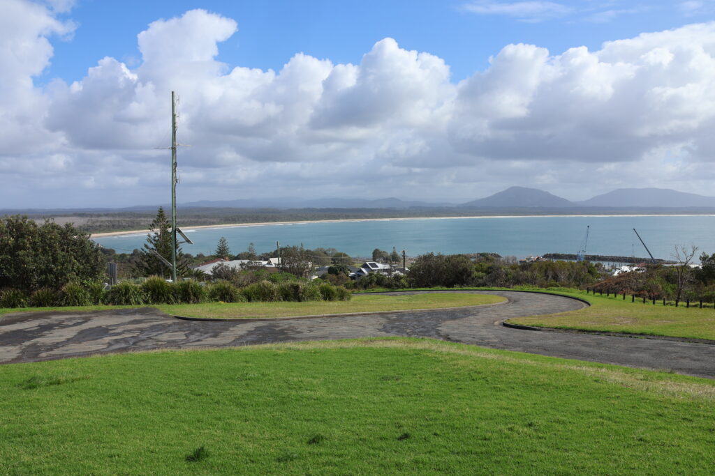 View of Crowdy Bay, with its white sandy beach curving in a perfect arc as seen from Crowdy Head. North Brother Mountain can be seen in the distance