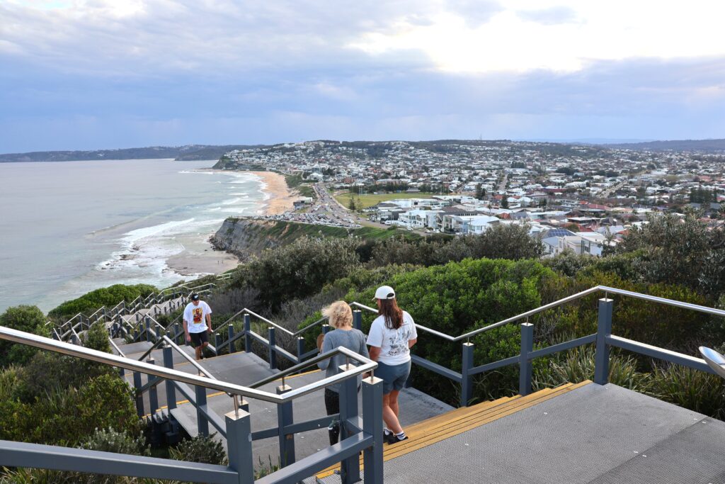 People get their evening exercise walking the stairs on the Bathers Way for stunning views overlooking Merewether Beach.