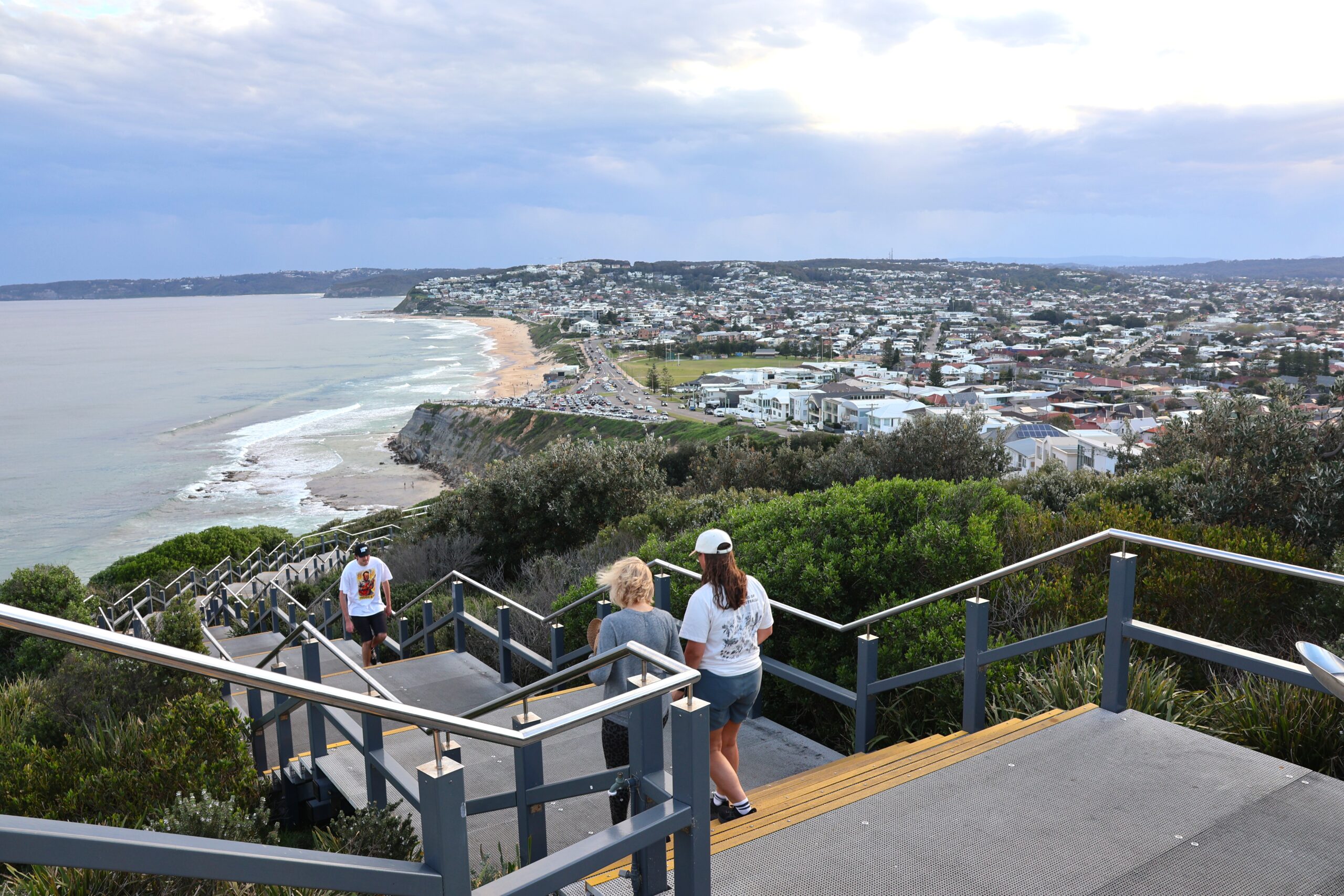 People get their evening exercise walking the stairs on the Bathers Way for stunning views overlooking Merewether Beach.