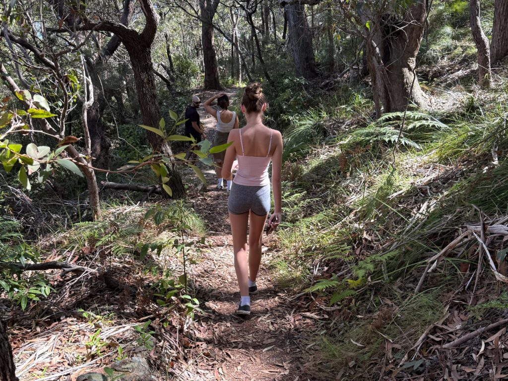 Girl walks through eucalyptus forest towards the WWII gun emplacements
